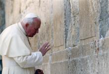 John Paul II places a prayer in the Western Wall in Jerusalem during a trip to Israel in 2000. Religion News Service file photo.