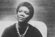 Gado / Getty Images A black-and-white photo of poet Lucille Clifton, sitting in a chair wearing black robes and several layered necklaces.