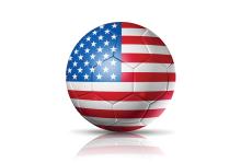 aboost / iStock An illustration of a soccer ball with an American flag all over its surface. It's on the ground of a completely white background.