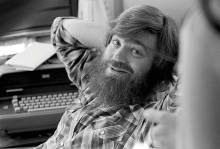 A young Jim Wallis in flannel smiling at the camera.