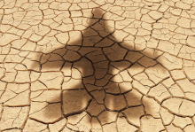 Illustration by Matt Chase The shadow of a military aircraft falls over parched, cracked land