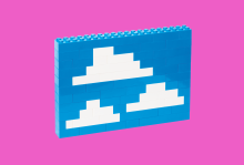 Legos built together to look like clouds in a blue sky.