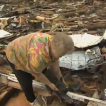 Screenshot of woman who found her dog amid tornado rubble in Moore, Okla.