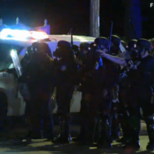 Police march in Ferguson. Image courtesy RNS.