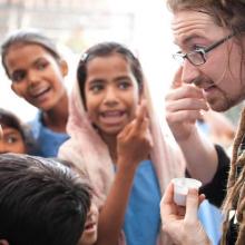 The author visits with children in India, 2010. Image via Facebook. 