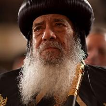 Pope Shenouda III, the Coptic Christian pontiff, listens to President Obama deli