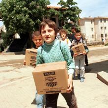Refugees carry USAID packages, Northfoto / Shutterstock.com
