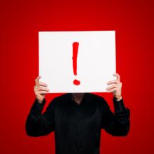 Man Holding Sign Exclamation Eugenio Marongiu / Shutterstock