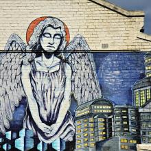 An angel surveys a city. Image courtesy Neale Cousland/shutterstock.com
