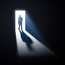  man walking through open doors, Mopic / Shutterstock.com