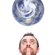 Man praying for the earth, Gandolfo Cannatella / Shutterstock.com