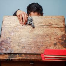 Student with a gun at school, LoloStock / Shutterstock.com