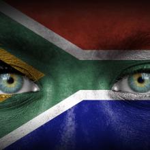South African flag over human face, Aleksandar Mijatovic / Shutterstock.com