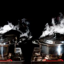 Two pots reach the boiling point. Image courtesy Showcake/shutterstock.com