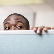 Curious man peeking over wall, Media Bakery13 / Shutterstock.com