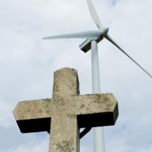 Cross in front of a wind farm, BESTWEB / Shutterstock.com