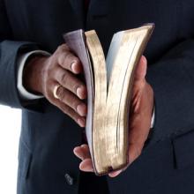 Pastor with Bible, Rob Marmion / Shutterstock.com