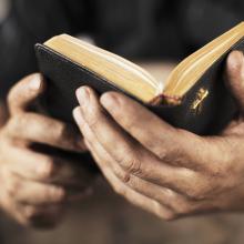 Hands holding a bible. Stocksnapper/Shutterstock.com