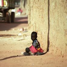 Photo: Child sitting in the dust in  Attila JANDI / Shutterstock.com