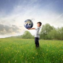 Child holding the earth, olly, Shutterstock.com