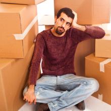 Man among moving boxes, William Perugini / Shutterstock.com