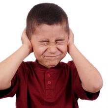 Boy covering his ears,  3445128471 / Shutterstock.com