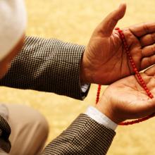 Hands with Muslim prayer beads, Omer N Raja / Shutterstock.com