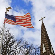 American flag and church steeple, Bobkeenan Photography / Shutterstock.com