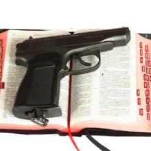 Religion and gun photo,  sagasan / Shutterstock.com