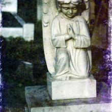 Stone cherub in London cemetery, nagib / Shutterstock.com