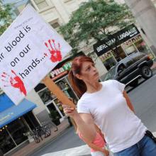 Victoria Ann Thorpe protests against the death penalty outside of a Spokane mall