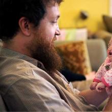 Eric Brown holds his two-month-old daughter, Pearl Joy, on Oct. 1, 2012. 