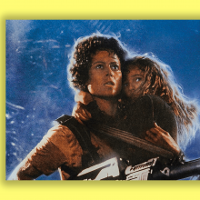 A scene from "Aliens" in which an adult is carrying a little girl as they look nervously into the distance.