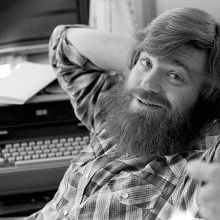 A young Jim Wallis in flannel smiling at the camera.