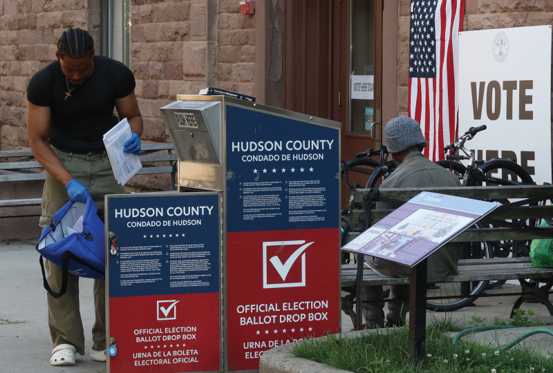 A poll worker collects mail-in ballots for the New Jersey primary election in June.