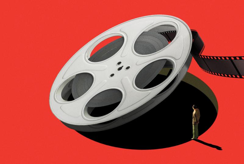 An illustration of a giant film reel being lifted up by an invisible force, revealing a bottomless pit. A man stands on the edge of the deep red floor, peering in as some of the film unspools over him out of frame.