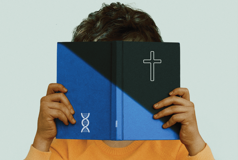 A child covers its face by holding up a blue book with a cross on the front cover and a DNA symbol on the back cover.
