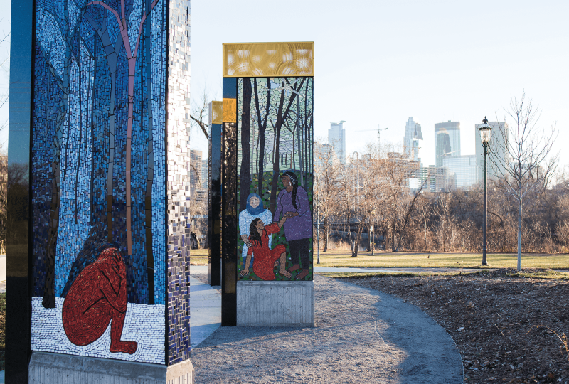 A Memorial to Survivors of Sexual Violence in Minneapolis. The murals are done with mosaics of blue, silver, brown and red colors.