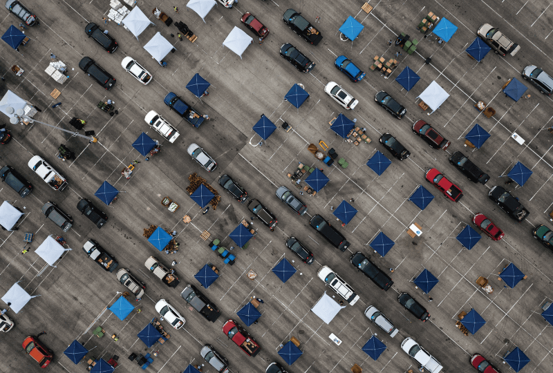 Aerial view of cars waiting in a food line in a parking lot in Texas.