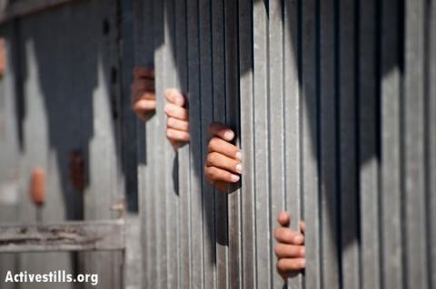 The hands of Palestinian men grip the steel bars at the Bethlehem checkpoint. (photo: RRB/Activestills.org) (photo: RRB/Activestills.org)