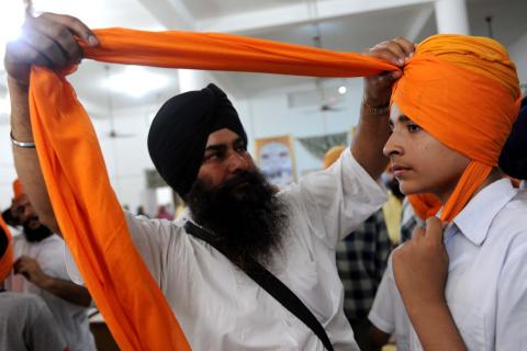 A Sikh boy has a turban tied over his head during a gathering for World Turban Day. NARINDER NANU/AFP/Getty Images NARINDER NANU/AFP/Getty Images