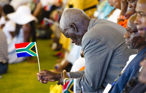 A man holds a national flag during celebrations marking Day Of Reconciliation 2011. Photo by Foto24/Gallo Images/Getty Images Photo by Foto24/Gallo Images/Getty Images