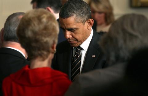 Preident Obama bows his head in prayer at the annual Easter Prayer Breakfast Wendesday. Photo by Win McNamee/Getty Images. Photo via Win McNamee/Getty Images