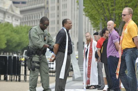 Rev. John L. McCullough of Church World Service arrested in front of the White House. Via United Methodist News Service Via United Methodist News Service