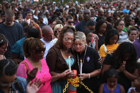 itia Stillwell and Lori Meade embrace and pray with thousands of others during a prayer vigil. Chip Somodevilla/Getty Images Chip Somodevilla/Getty Images