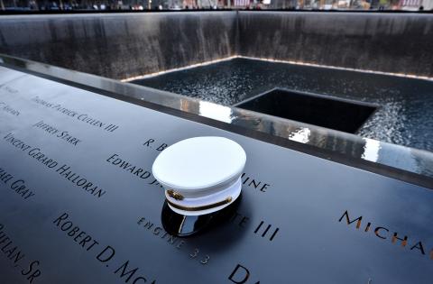 A firefighter's hat sits on names of firefighters who died at the South Pool, during 911 anniversary ceremonies. JUSTIN LANE/AFP JUSTIN LANE/AFP/GettyImages