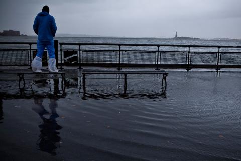 A man watches the waves in New York Harbor from Battery Park, New York City. Andrew Burton/Getty Images Andrew Burton/Getty Images