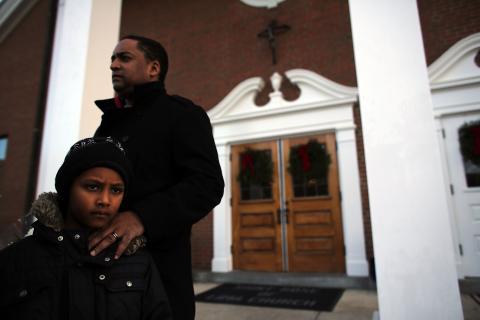 David Echevarria (7) and his father Daniel from Newtown stand outside of a church. Spencer Platt/Getty Images Spencer Platt/Getty Images