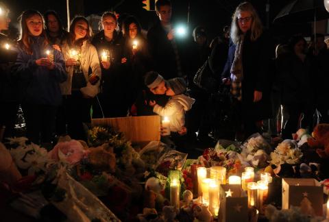 Rachel Pullen (C) kisses her son Landon DeCecco at a memorial for victims near the school. Mario Tama/Getty Images Mario Tama/Getty Images
