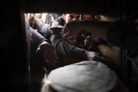 Syrians wait for bread at a bakery in the northern city of Aleppo on December 31. JM LOPEZ/AFP/Getty Images JM LOPEZ/AFP/Getty Images